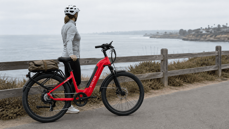 E11EVEN ELEANOR Step-Thru Electric Bike in red with black accents, step-thru frame, rear cargo rack, and thick tires.